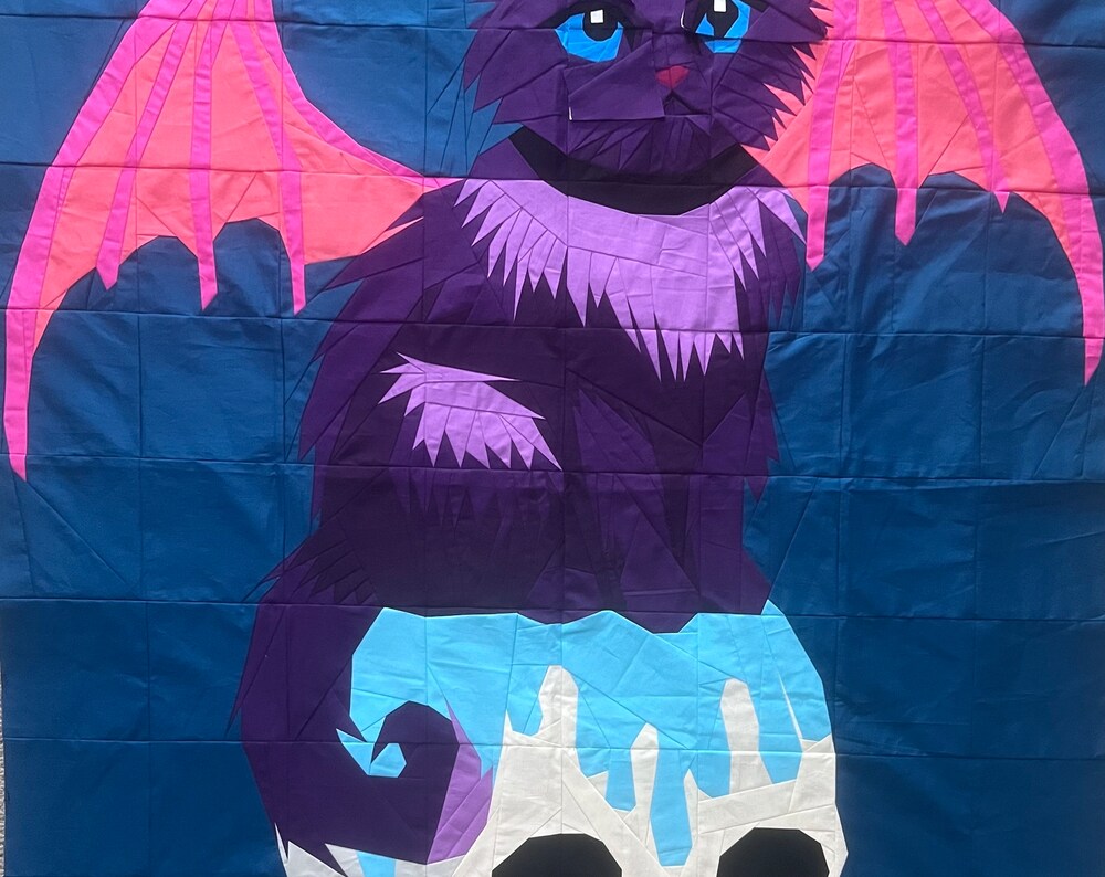 Close-up of the purple cat and skull in a sewn Fluffy foundation paper piecing quilt