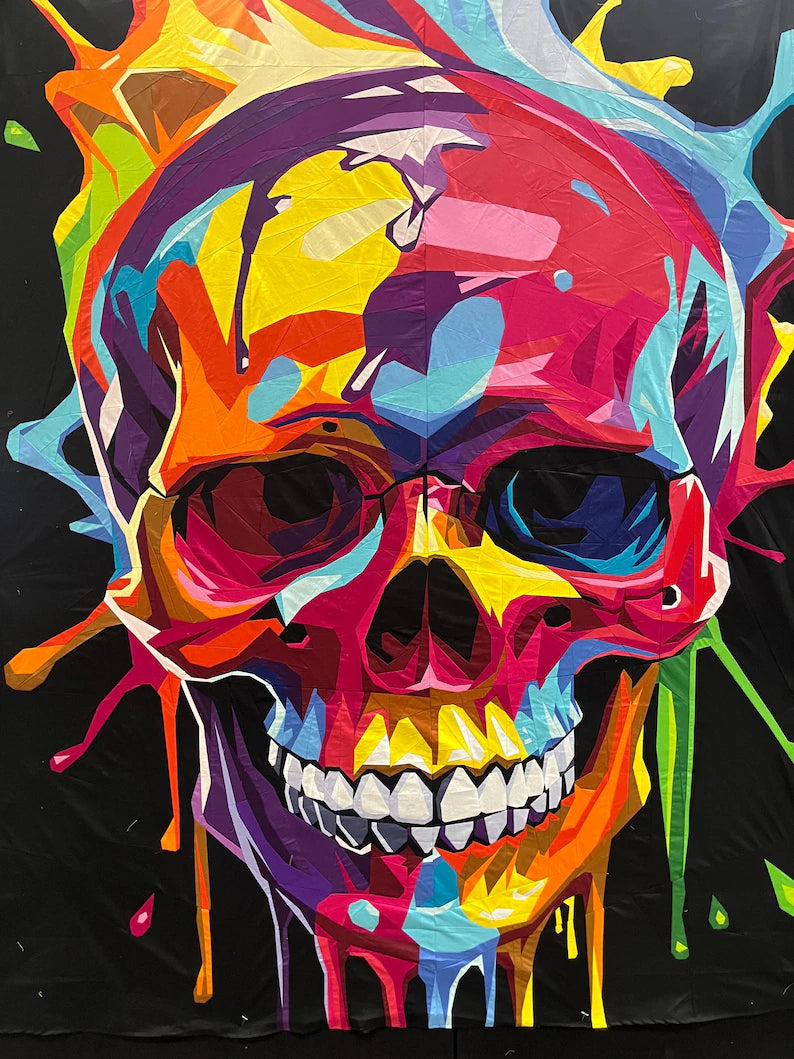 Splash Skull quilt design with a brightly coloured paint-splashed skull on a black background